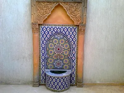 a bathroom with a blue and white toilet in a wall at Silia Appartements in Temara