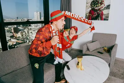 a man is holding a child with a sign at New Hotel Piscine Wellness & Spa in Casablanca