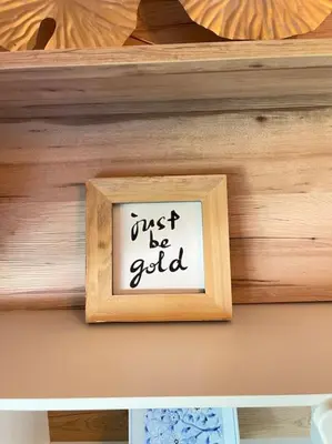 a wooden frame with the words just be gold on a shelf at BEST unit NEAR Casablanca AIRPORT in Casablanca