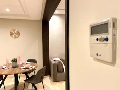 a dining room with a table with chairs and a room with a wall at Best in Town - Central -Comfortable-in Racine in Casablanca