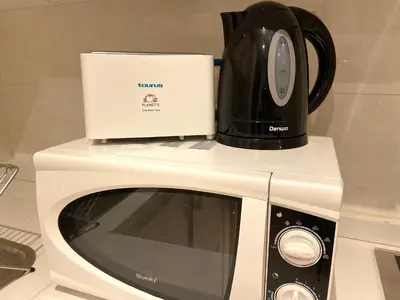 a microwave with a laptop on top of it at Best in Town - Central -Comfortable-in Racine in Casablanca