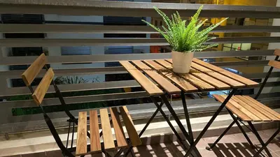 a wooden table with a potted plant on a balcony at Best in Town - Central -Comfortable-in Racine in Casablanca