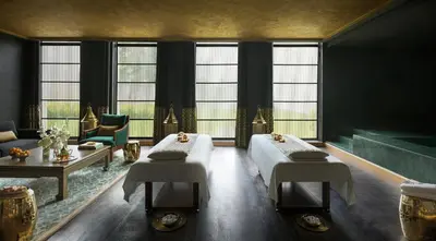 a room with two beds and a couch and windows at The Ritz-Carlton Rabat, Dar Es Salam in Rabat