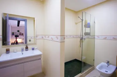 a bathroom with a sink and a glass shower at Mosquee & Sea View Casablanca in Casablanca