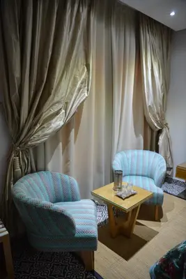 two chairs and a coffee table in a room at Aralia Boutique Hôtel in Rabat