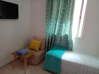 a small room with a couch and a window at Dar Khalifa Airport in Nouaseur