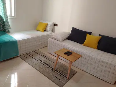 a living room with a couch and a coffee table at Dar Khalifa Airport in Nouaseur
