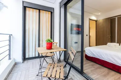 a room with a bed and a table with a potted plant at Stylish & Chic Flat - Best Place - New Building in Casablanca