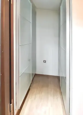 an empty room with white cabinets and a wooden floor at Spacious apartment in Nouaseur of 167 m² in Nouaseur