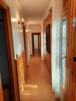 a hallway of a house with a long corridor at Palmeraie skhirat1 in Skhirat