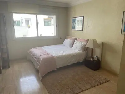 a bedroom with a bed and a window at Residence Elite appartement de luxe in Casablanca