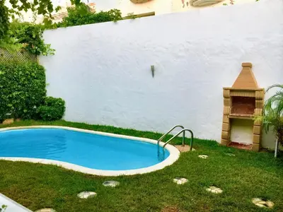 a small swimming pool in a yard with a grill at Elegant villa in Dar Bouazza with year-round private pool in Dar Bouazza