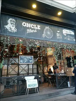 a store front of a bicycle shop with people sitting at tables at Dior D'Anfa in Casablanca