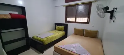 a small room with two beds and a window at Mohammed V International Airport HOUSE in Nouaseur