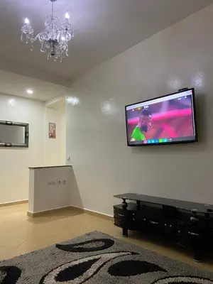 a living room with a flat screen tv on a wall at Mohammed V International Airport HOUSE in Nouaseur