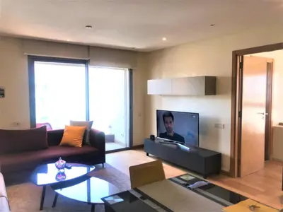 a living room with a couch and a tv at Charming Appartement With a Beautifull View 41 in Casablanca