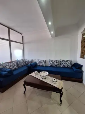 a living room with a blue couch and a table at Home Sweet Home Just a 2-Minute Walk to the Tram