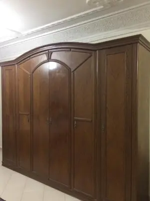 a large wooden cabinet in a room with a ceiling at Home Sweet Home Just a 2-Minute Walk to the Tram