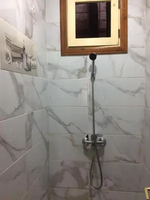 a shower with a hose in a bathroom at Home Sweet Home Just a 2-Minute Walk to the Tram
