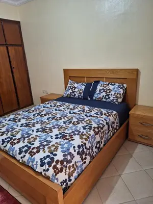 a bedroom with a bed with a blue and white comforter at Home Sweet Home Just a 2-Minute Walk to the Tram