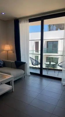 a living room with a couch and a large window at Luxury Anfaplace Living Resort in Casablanca