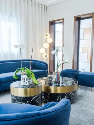 a living room with blue couches and a coffee table at Makass Appart Hotel in Rabat
