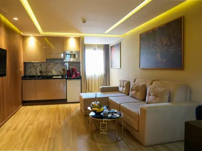 a living room with a couch and a table at First Suites Hôtel in Rabat