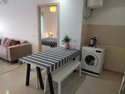 a living room with a table and a washing machine at Atlantic studio in Atlantic Plaza with Free parking , Available public bus to,from casa port station and downtown in Casablanca