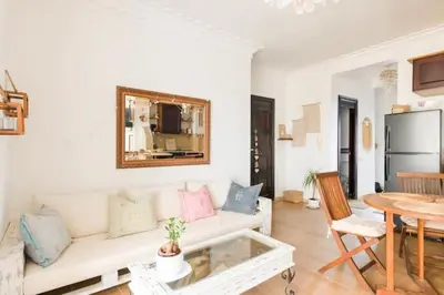 a living room with a white couch and a table at Sea view Tamaris Dar Bouazza in Tamaris