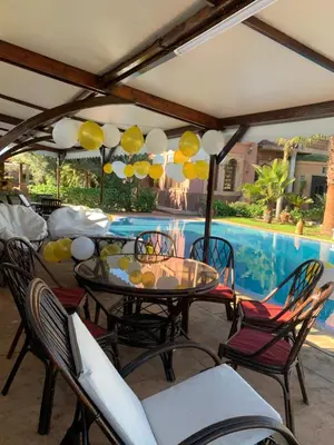 a patio with a table and chairs and a pool at Equi Palace & SPA Near Aeroport in Berrechid