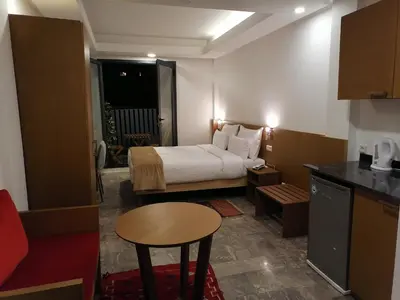 a small hotel room with a bed and a table at Casa City Break Appart hôtel in Casablanca