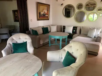 a living room with a couch and chairs and a table at Palmeraie skhirat 2 in Skhirat