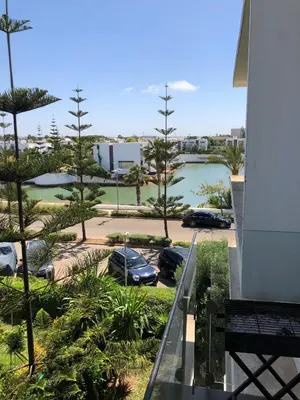 a view from a balcony of a parking lot with cars at Eden Island Apartment with a View in Sidi el Haj Bou Derbala