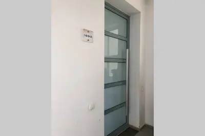 a glass door in a building with a sign on it at Eden Island Apartment with a View in Sidi el Haj Bou Derbala