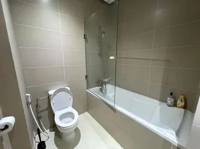 a bathroom with a toilet and a tub and a sink at 5 Star Apartment Near Airport in Nouaseur