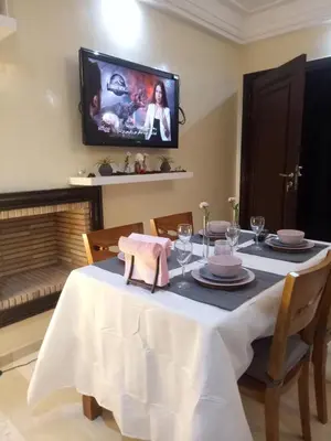 a dining room with a table with a tv on the wall at Apartment with Terrace in Casablanca