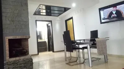 a living room with a table and a fireplace at Apartment with Terrace in Casablanca