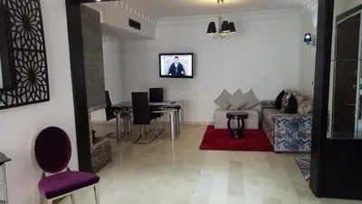 a living room with a table and a couch at Apartment with Terrace in Casablanca