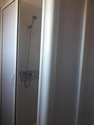 a bathroom with a shower and a door with a shower at Maison vintage Rabat Agdal in Rabat