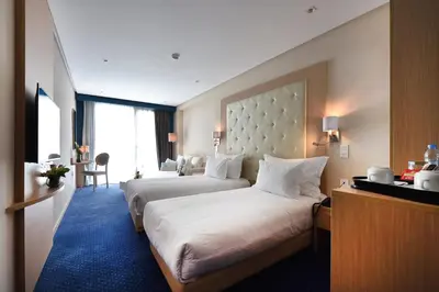 a hotel room with two beds in a room at Flower Town Hotel & Spa in Rabat