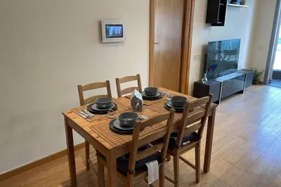 a wooden table with chairs and a dining room at Brand new, Stylish & Well located Apartment in Casa-Marina 12 in Casablanca