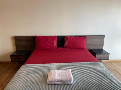 a bedroom with a bed with red sheets and red pillows at Brand new, Stylish & Well located Apartment in Casa-Marina 12 in Casablanca