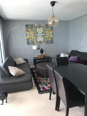 a living room with a couch and a table at Chez Didier Tamaris Beach in Dar Bouazza