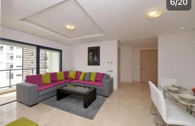 a living room with a couch and a table at Prestigia Rabat Hay Riad Premium Apartments in Rabat