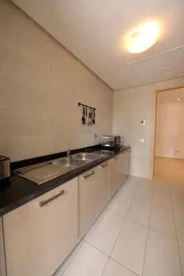 a kitchen with a sink and a counter at Prestigia Rabat Hay Riad Premium Apartments in Rabat