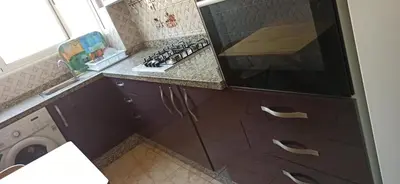 a kitchen with a stove and a washing machine at Maison de la famille in Casablanca