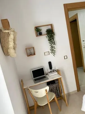 a desk with a laptop and a chair in a room at Mansbay Beach, Vue sur Mer, accès Plage à pied, Mohammedia in Mohammedia