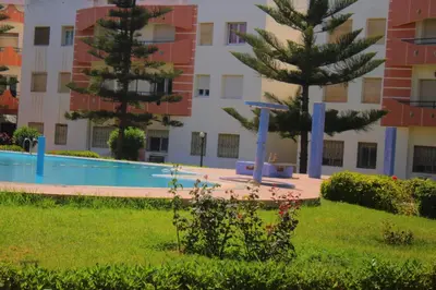 a swimming pool in front of a building at Mohammedia pour les vacances in Mohammedia