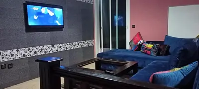 a living room with a couch and a flat screen tv at Studio meublé Casablanca in Casablanca