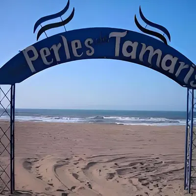 a sign on a beach with the words periles tammen at Appartement au Bord de la Mer in Casablanca